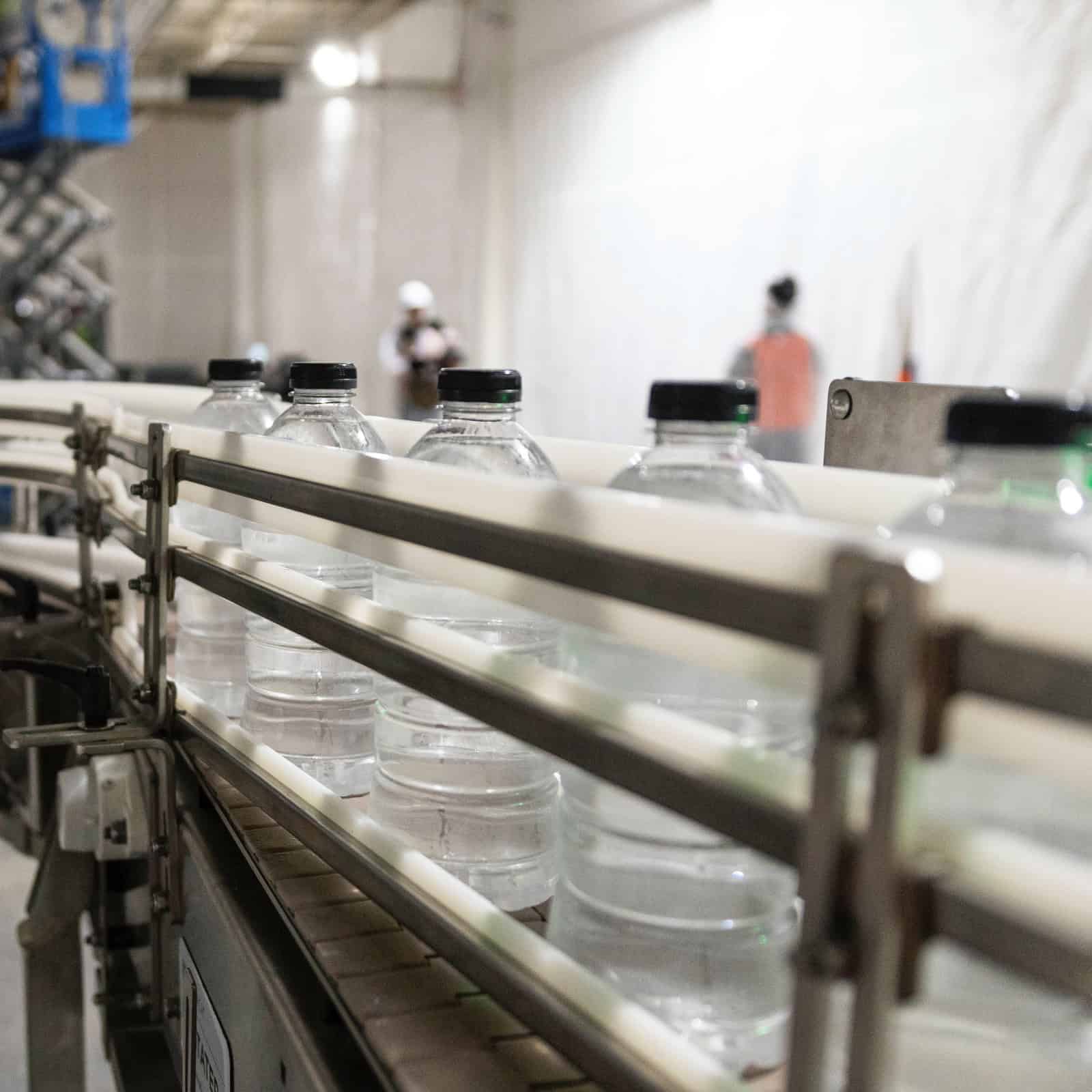 ready-to-drink bottles circling around a conveyor belt